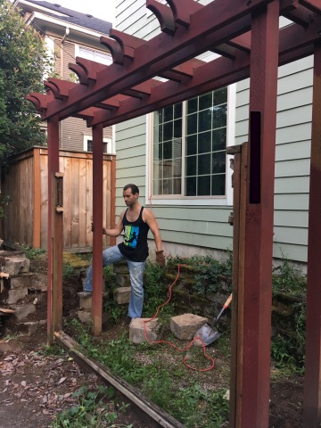 A red wooden pergola/trellis thing